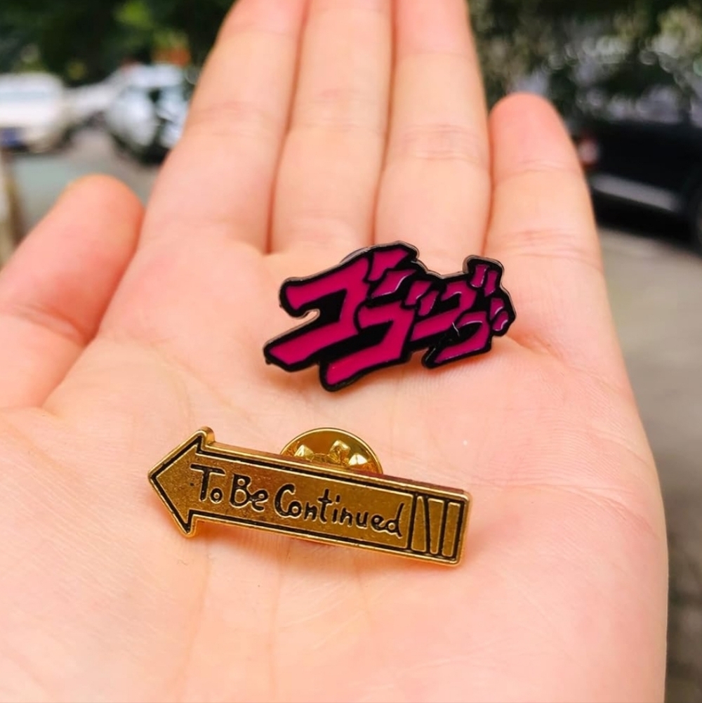 Enamel Pin Set — Pink Japanese Text & Gold 'To Be Continued' Arrow JoJo's
